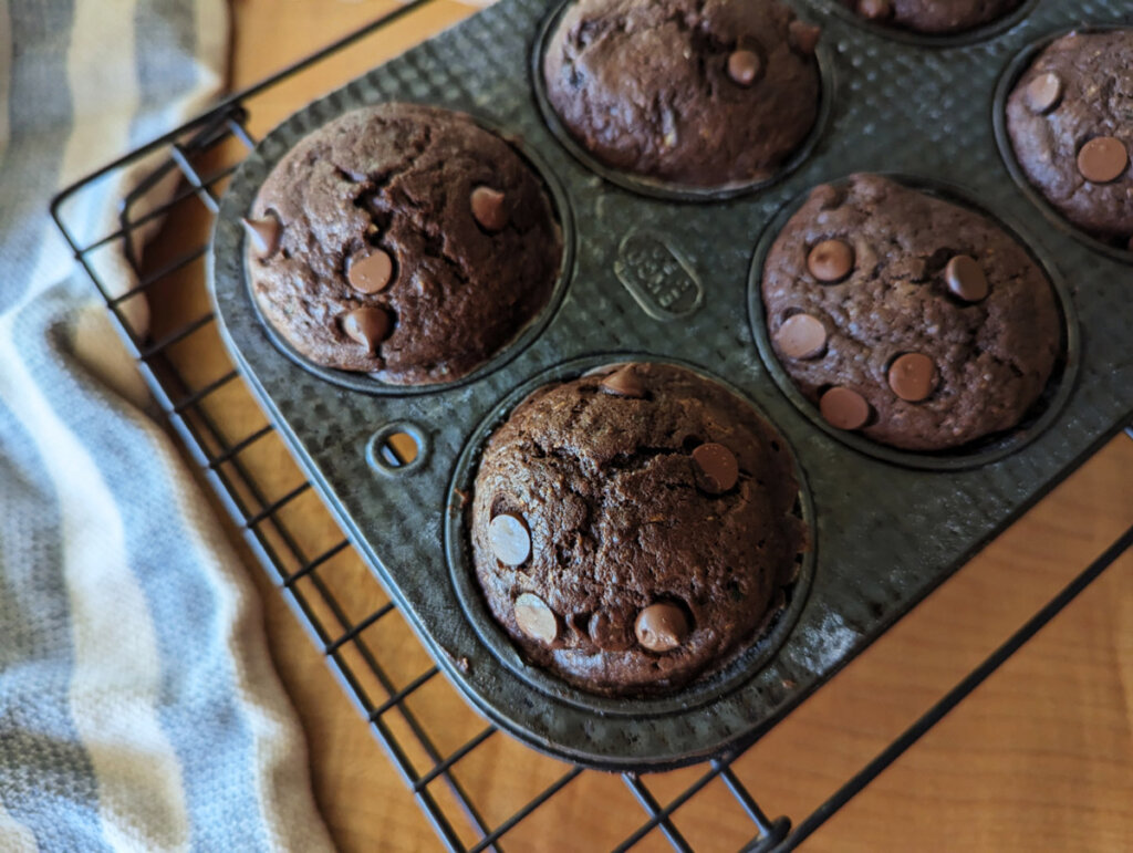 Double chocolate zucchini muffins in a muffin tin.