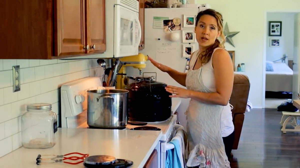 A woman preparing a waterbath canner for processing.