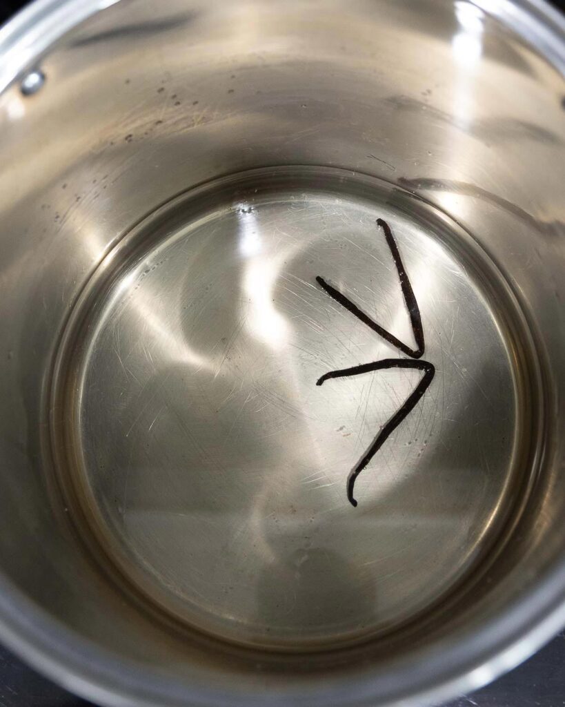 Grape juice and vanilla beans in a stock pot to make jelly.