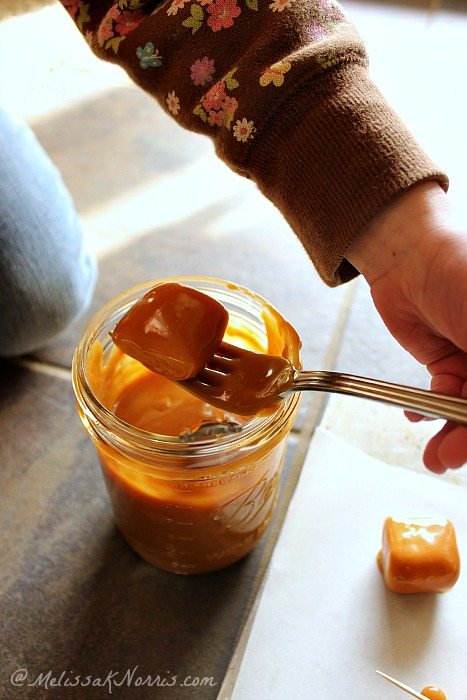 Homemade Chocolate Caramel Covered Marshmallows with Sea Salt in the dipping phase https://melissaknorris.com/2014/02/04/homemade-chocolate-caramel-covered-marshmallows-sea-salt/