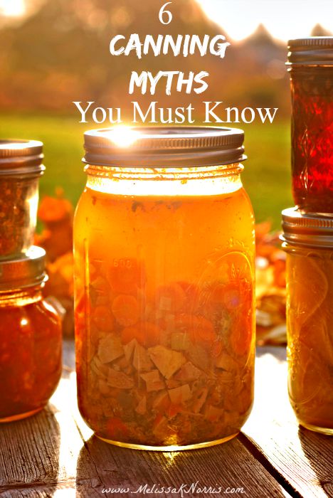 Five jars of home canned food sitting on an outdoor table with the sun setting in the background.