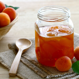 Canned apricots in a Mason jar.