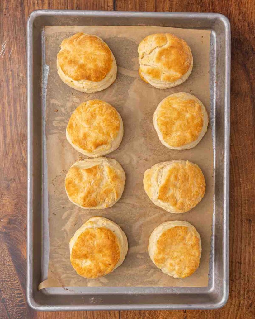 Freshly baked biscuits on a baking sheet.