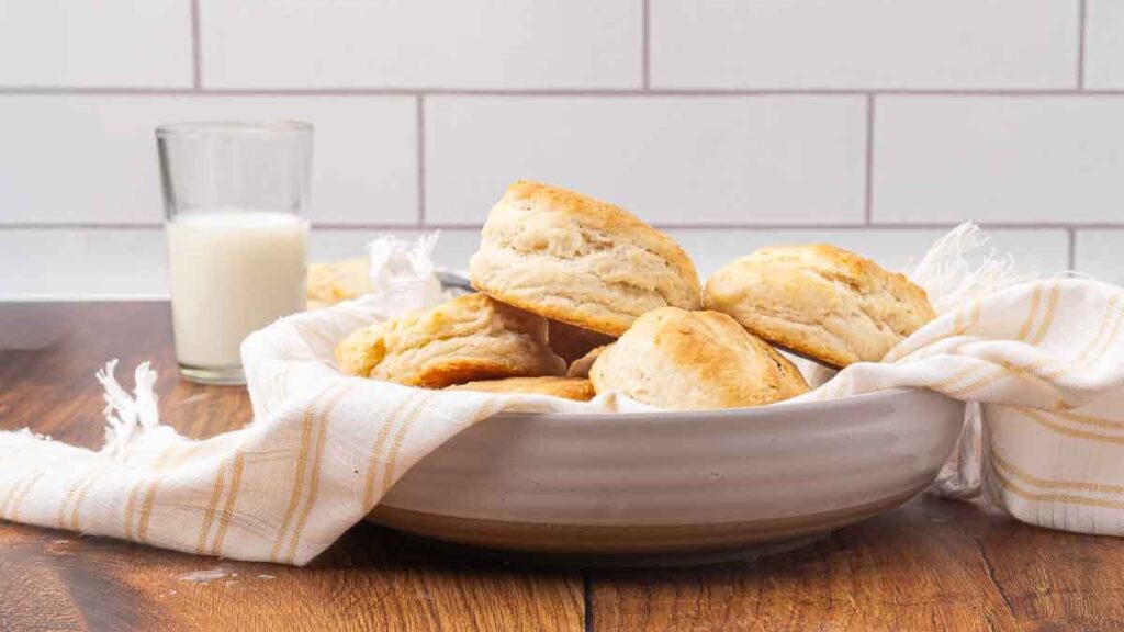 A white bowl filled with baked biscuits.