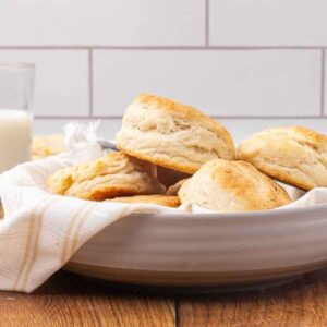 A white bowl filled with baked biscuits.