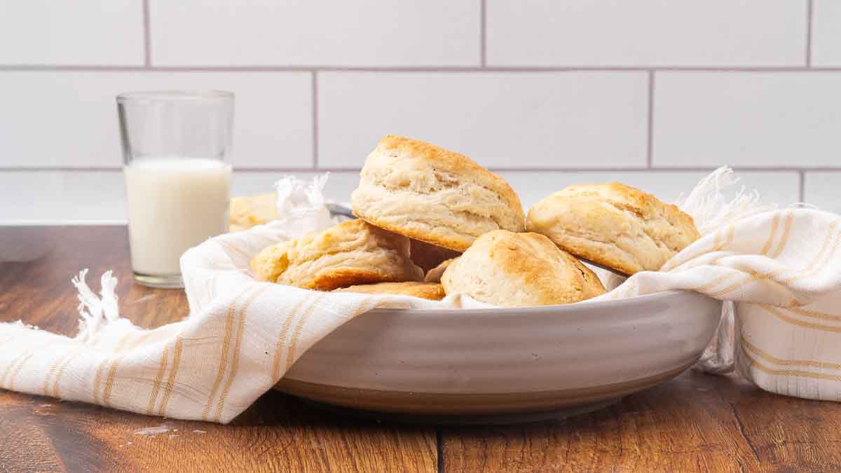 A white bowl filled with baked biscuits.