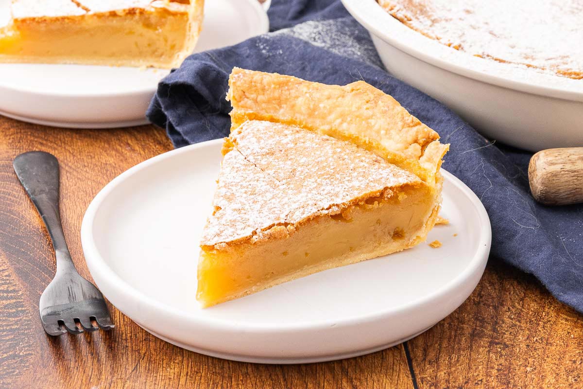 A slice of vinegar pie on a white plate.