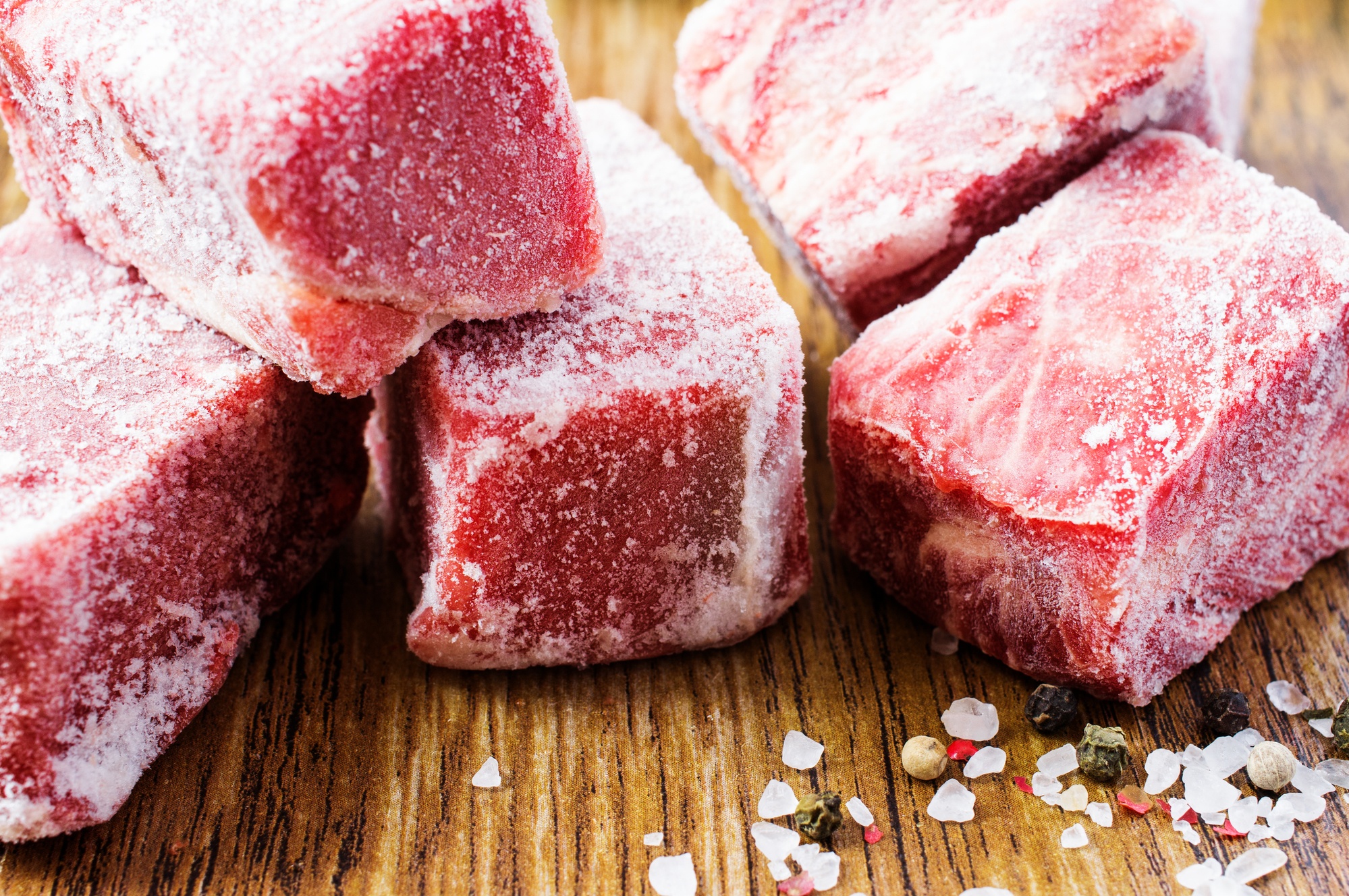 Frozen pieces of beef on a table..