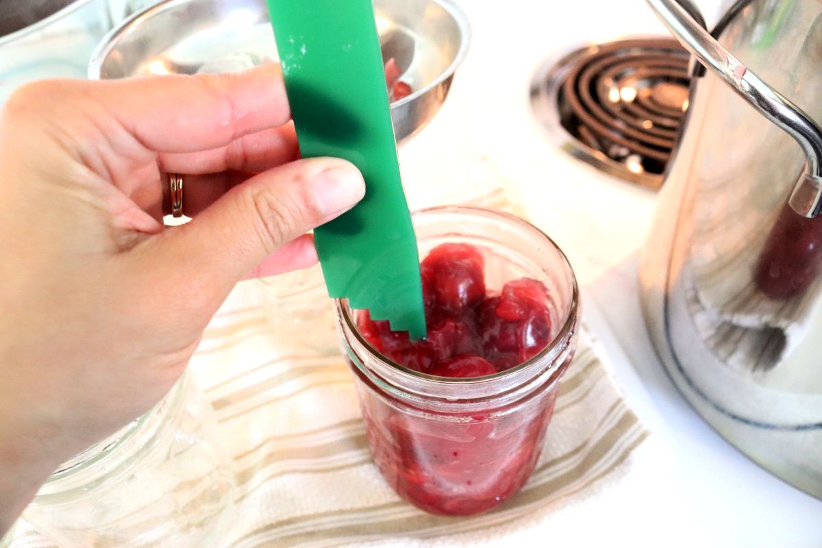 measuring headspace on home canned jar of cherry pie filling