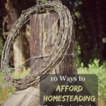 Image of a roll of barbed wire hanging on a weathered fence post. Text overlay says, "10 Ways to Afford Homesteading When You Are Broke".
