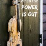 Picture of an antique violin hanging on a painted barn wood door. Text overlay says, "6 Things to Do for Fun When the Power Goes Out".