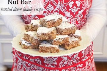 Woman in a red and white apron holding a plate of date nut bars. Text overlay says, "Old Fashioned Italian Date Nut Bar".