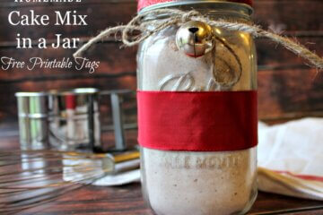 A jar of homemade cake mix tied with red ribbon and a bell.