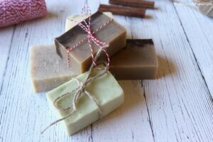 Homemade soap tied with twine as gifts sitting on a table.
