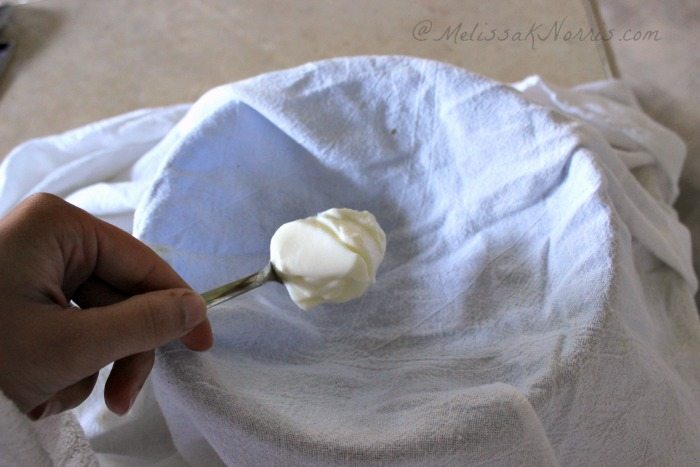 Yogurt being placed into cheesecloth to be strained for whey.