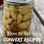 Image of a mason jar filled with canned garlic cloves. Text overlay says, "How to Safely Convert Recipes for Canning".