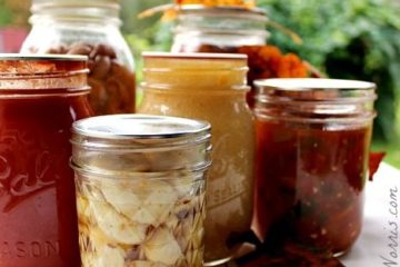 Pinterest pin contains an image of various glass canning jars filled with garlic, tomato sauce, salsa, and beans. Text overlay says "6 Fall Canning Recipes".