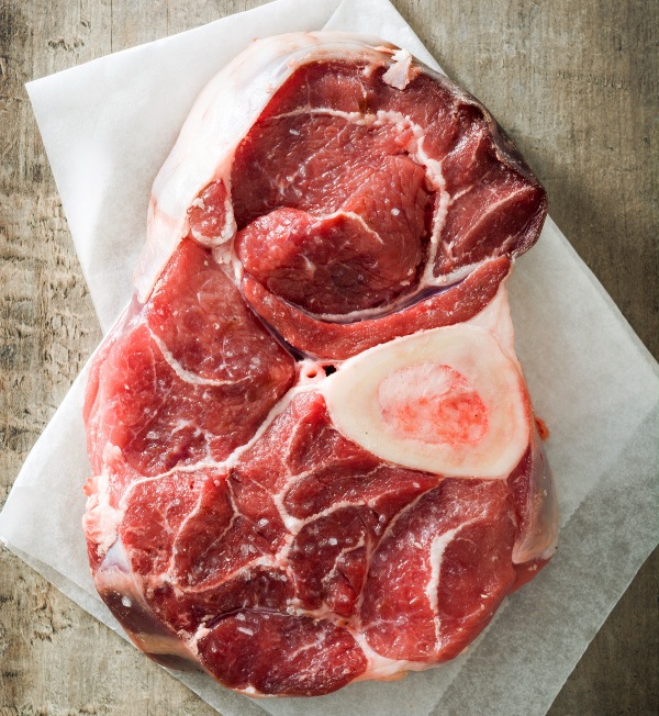 A steak on a piece of butcher paper on a counter.