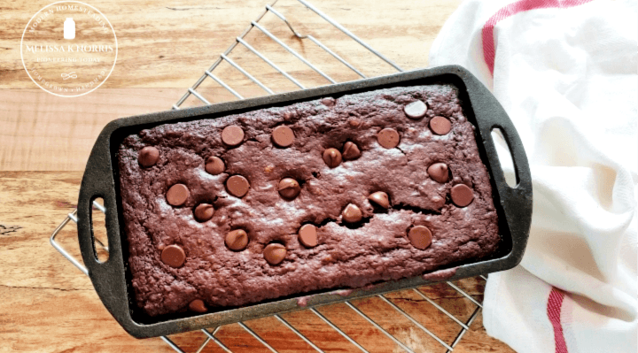 Cast iron loaf pan with chocolate sourdough bread inside.