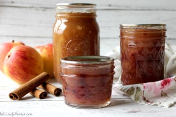 three different sized jars of apple pie filling and a smaller jar of apple pie jam.
