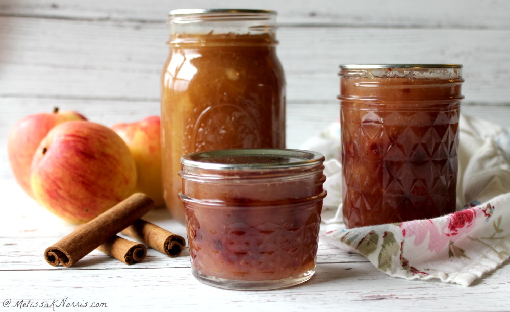 Jars of apple pie jam sitting on a counter.