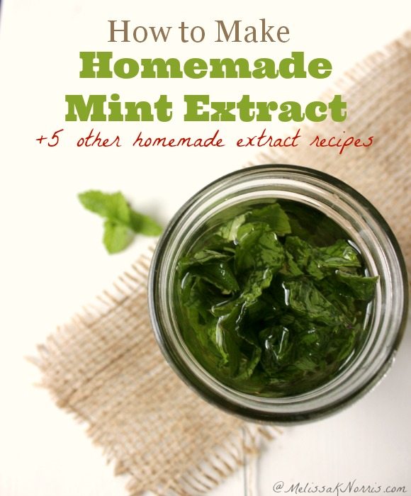 Mint leaves in a mason jar with alcohol being poured over the top.