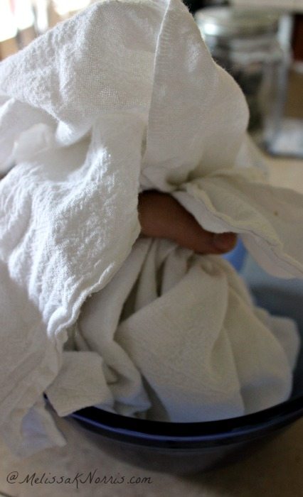 A tea towel folded up with yogurt inside to strain.