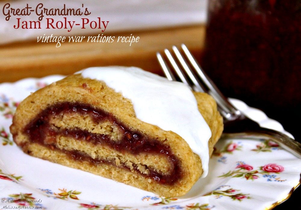 Image of a slice of jam roly poly served on a decorative plate. A jar of raspberry jam is sitting in the background. Text overlay says, "Great-Grandma's Jam Roly Poly - Vintage War Rations Recipe".