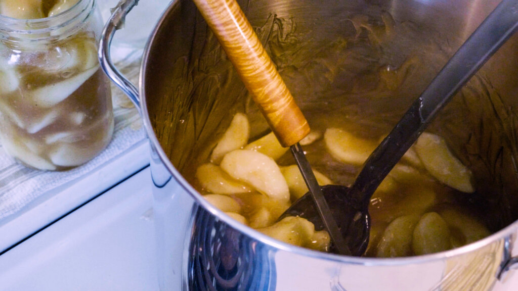 Apple pie filling in a large pot.