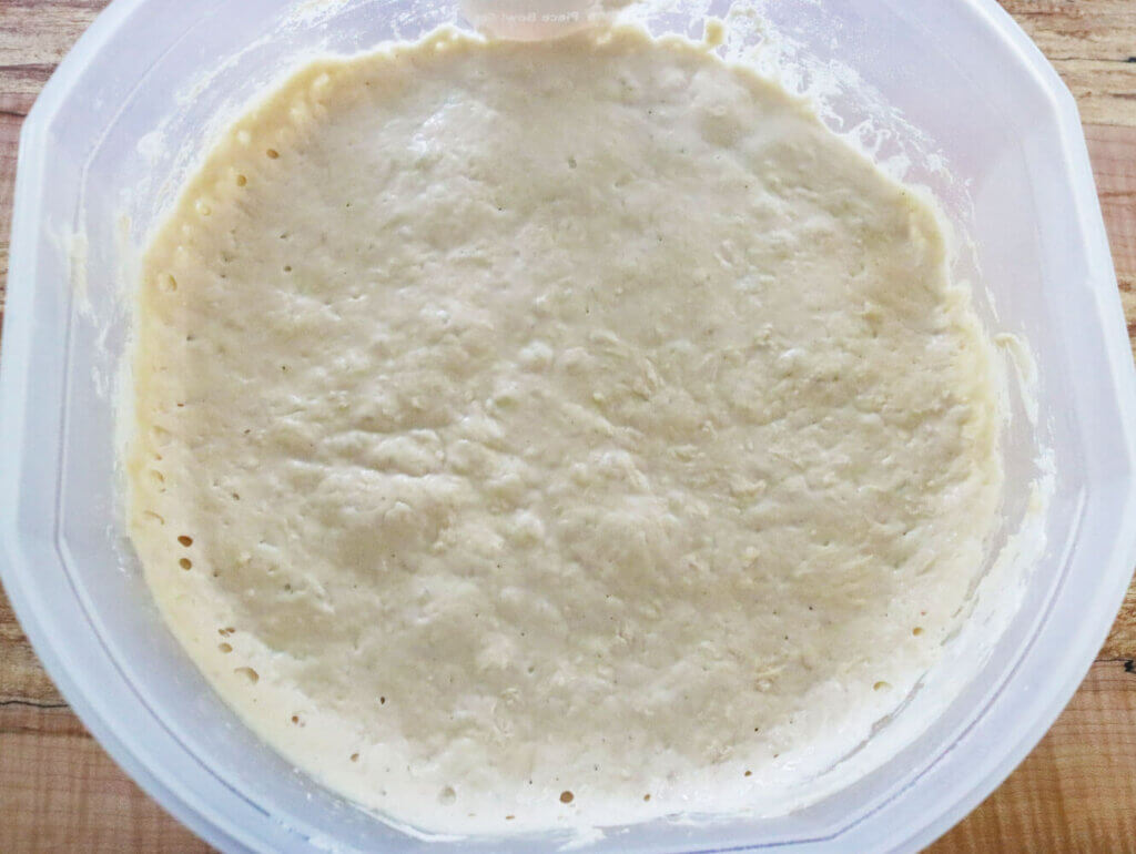 A large bowl of bread dough.
