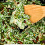 Pinterest pin with an image of green bean casserole and a wooden spoon.