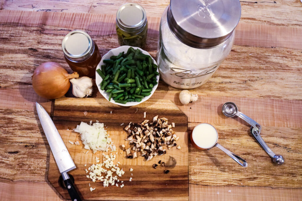 Ingredients needed to make homemade green bean casserole on a counter.