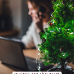 Picture of a woman sitting at a desk looking sad. Pinterest pin for how to handle emotions during the holidays with COVID realities.