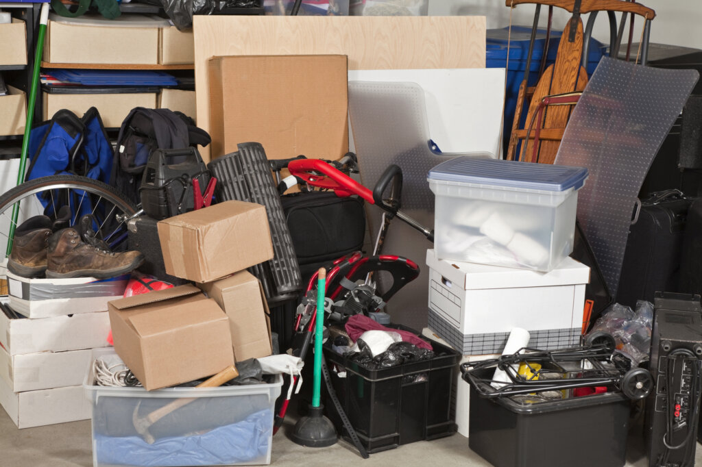 Photo of a very cluttered and messy garage.