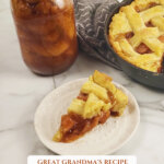 Pinterest pin for the secrets to the best flaky pie crust recipe with an image of a cast iron skillet with an apple pie, and a slice of the pie on a small white plate.
