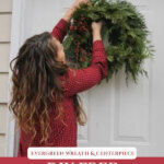 Pinterest pin of a woman hanging a homemade wreath on the front door.