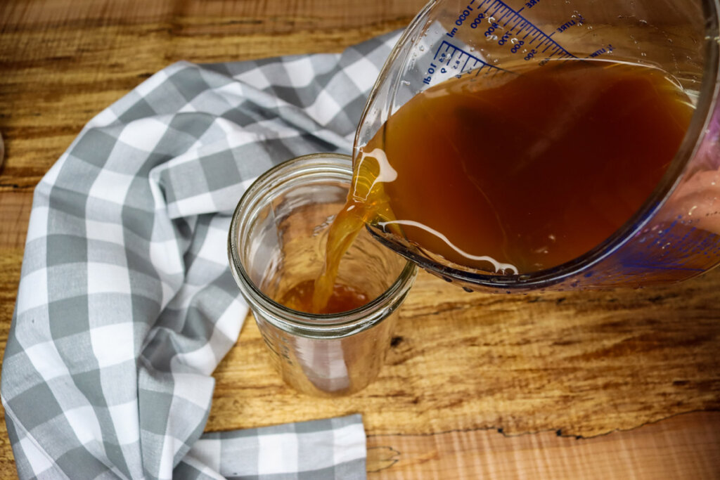 Chai Tea Concentrate being poured into a mason jar.