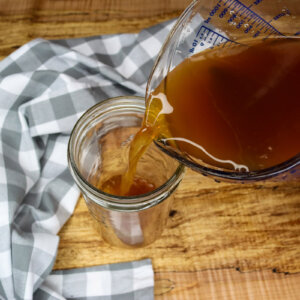 Chai Tea Concentrate being poured into a mason jar.