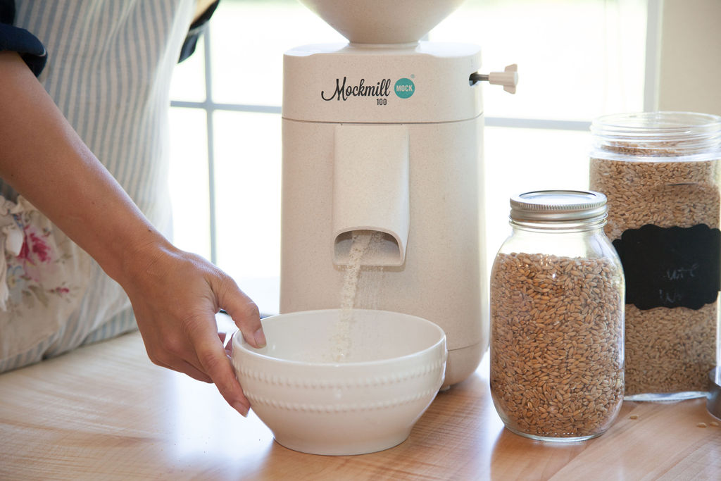 Mockmill grain mill grinding grain into a white bowl.