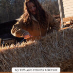 Pinterest pin with an image of a woman lifting a bale of hay. Text overlay says, "How I Stay Fit on the Homestead".
