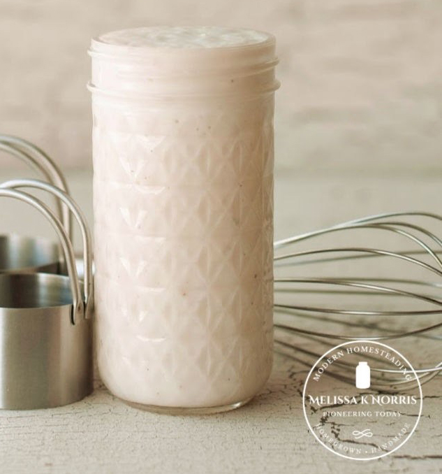 Mason jar of condensed cream of soup with a whisk in the background.