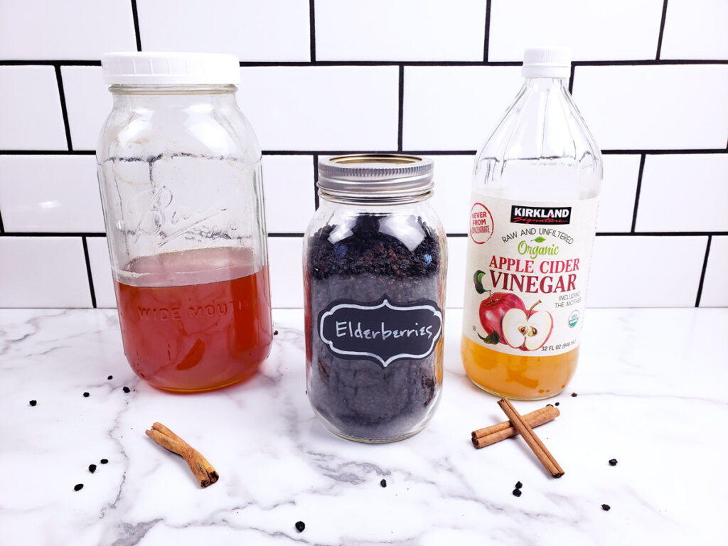 Ingredients for elderberry syrup: honey, dried elderberries and apple cider vinegar.