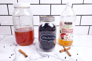 Ingredients for elderberry syrup: honey, dried elderberries and apple cider vinegar.