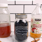 Pinterest pin for homemade elderberry syrup with images of elderberry syrup.