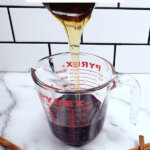 Pinterest pin for homemade elderberry syrup with images of elderberry syrup.