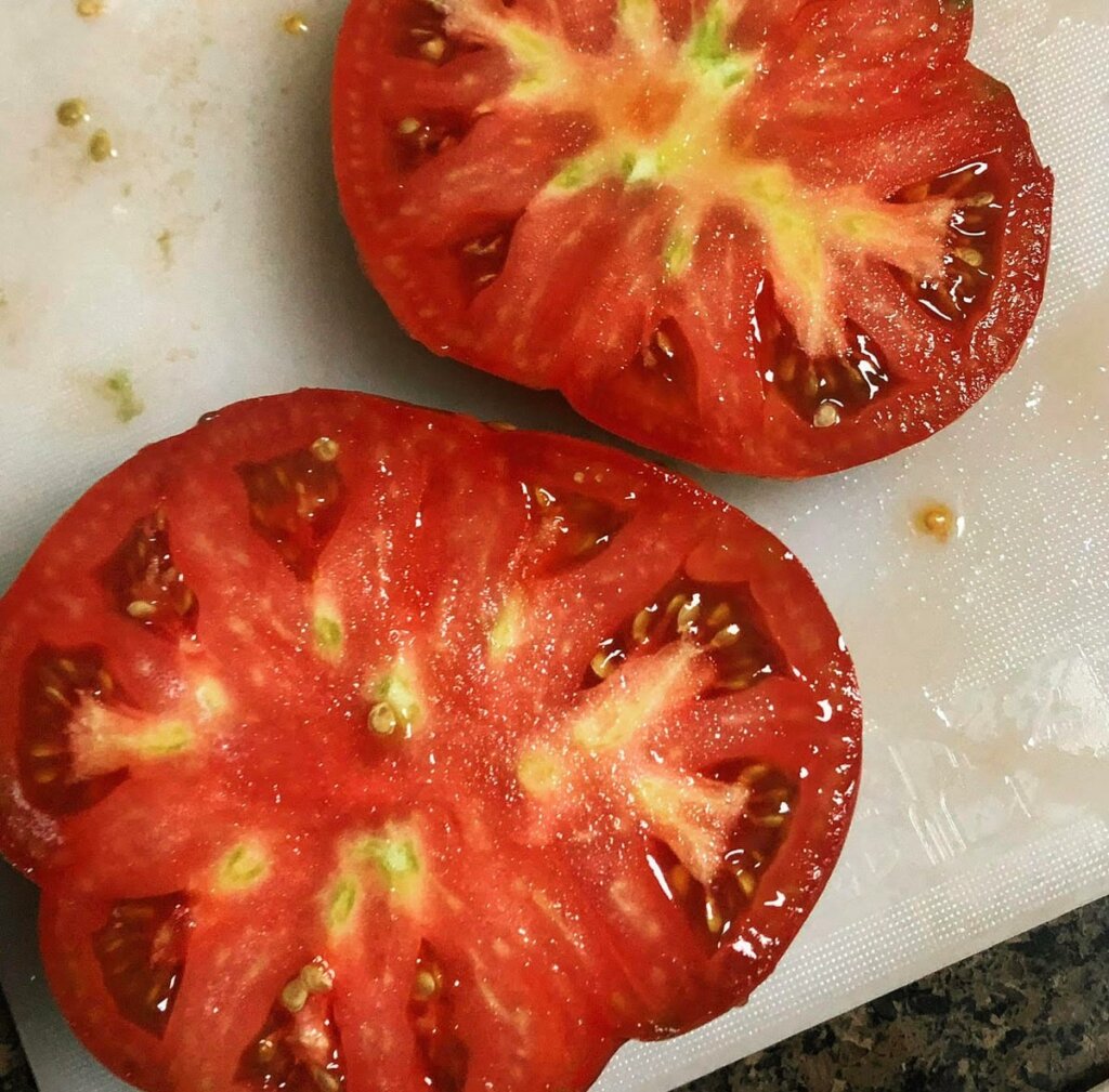 Image of a large tomato sliced in half.