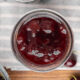 A bird's eye view of a jar full of cherry jam.