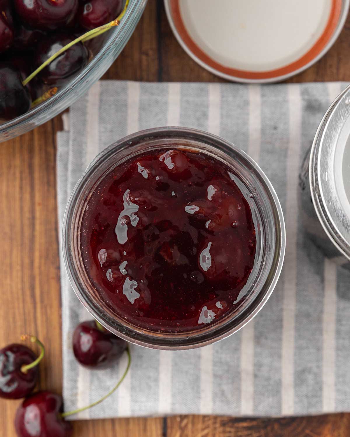A bird's eye view of a jar full of cherry jam.