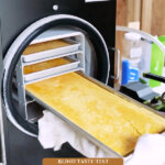 Pinterest pin for how to freeze dry eggs. Image of tray of freeze dried eggs coming out of the freeze dryer.