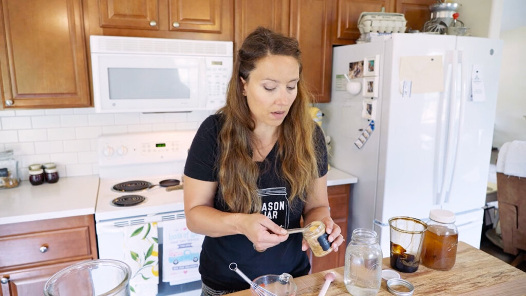 A woman measuring out dried ginger for ginger water.